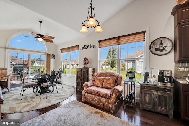 interior space featuring lofted ceiling, dark hardwood / wood-style floors, and ceiling fan with notable chandelier