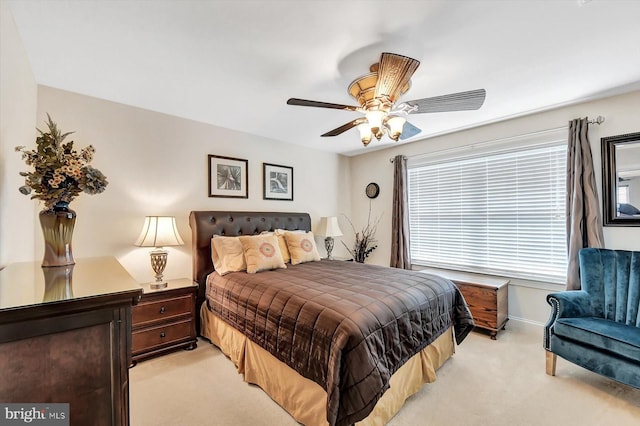 bedroom with ceiling fan and light colored carpet