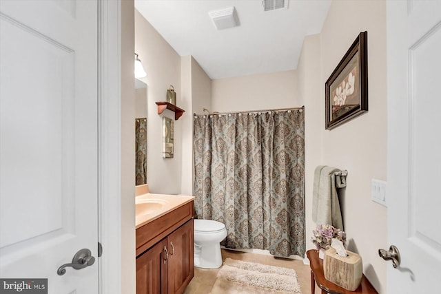 bathroom with vanity, walk in shower, and toilet