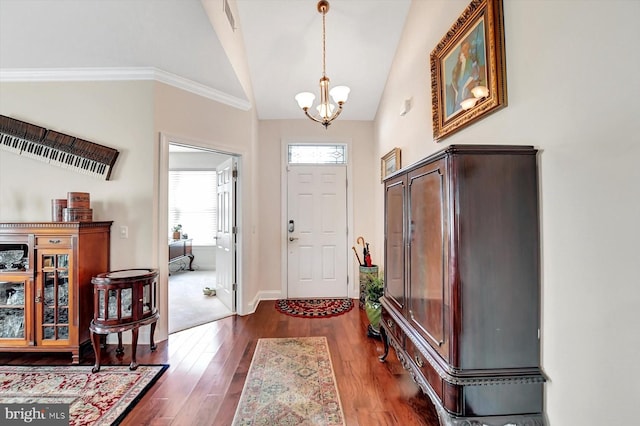 entryway featuring dark hardwood / wood-style floors, high vaulted ceiling, and a notable chandelier