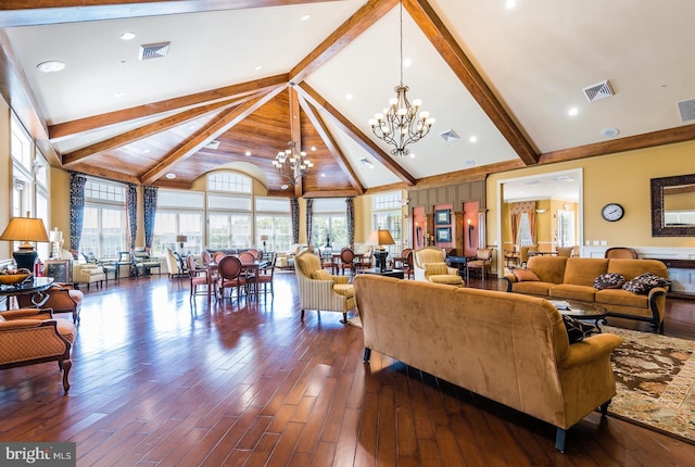 living room with hardwood / wood-style flooring, beam ceiling, a chandelier, and high vaulted ceiling