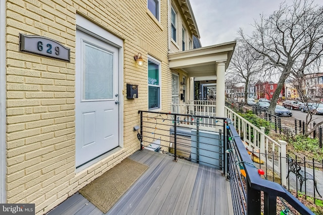 view of exterior entry featuring brick siding