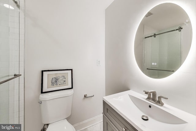 bathroom with an enclosed shower, vanity, and toilet