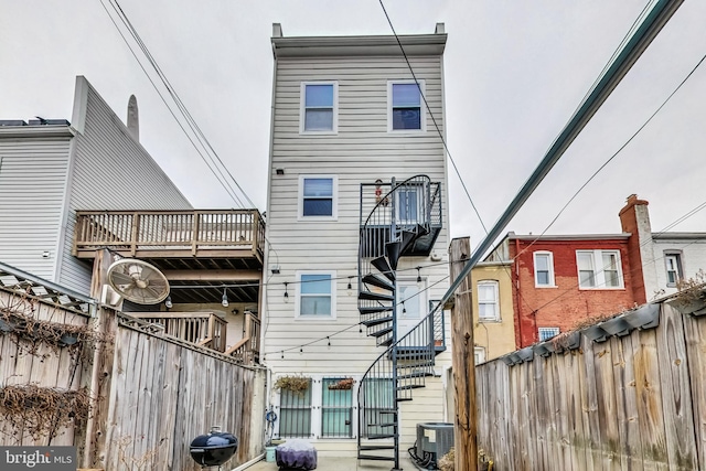 rear view of house with central AC unit