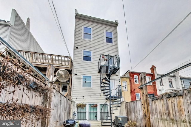 rear view of property featuring cooling unit