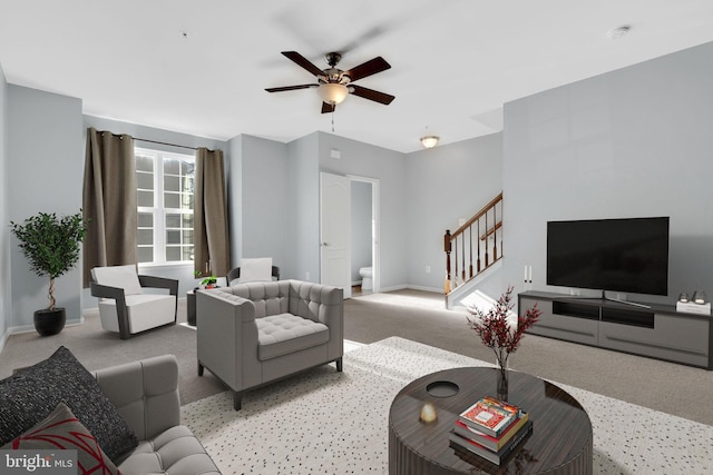 carpeted living room with ceiling fan