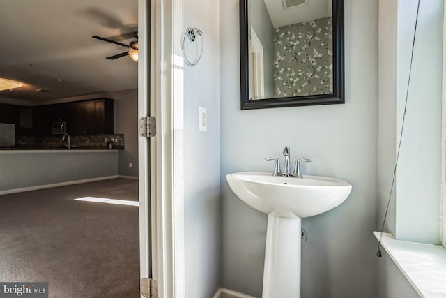 bathroom featuring ceiling fan and sink