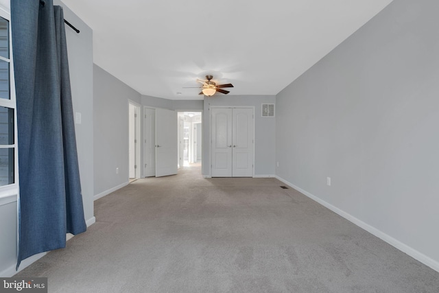 spare room with light carpet and ceiling fan