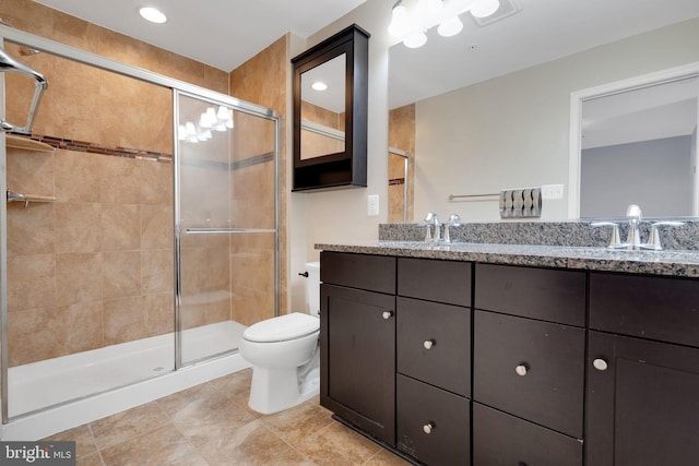 bathroom with toilet, a shower with door, and vanity