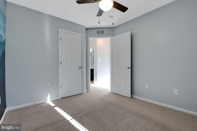 unfurnished bedroom featuring light carpet and ceiling fan