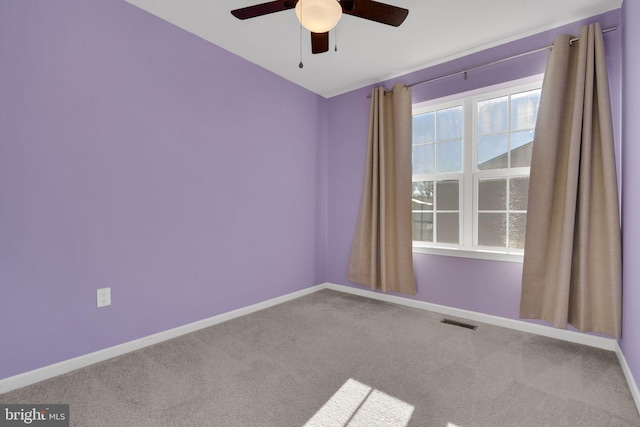 empty room featuring ceiling fan and carpet flooring