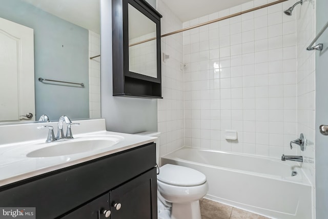 full bathroom featuring toilet, vanity, tile patterned flooring, and tiled shower / bath combo