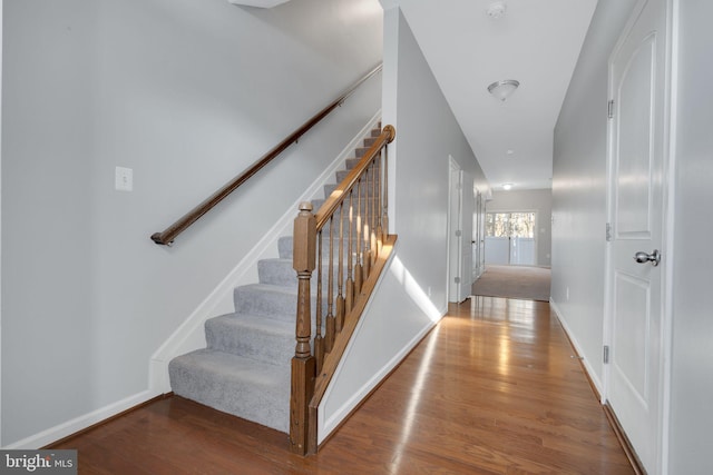 stairs featuring wood-type flooring