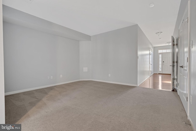 unfurnished room with light carpet