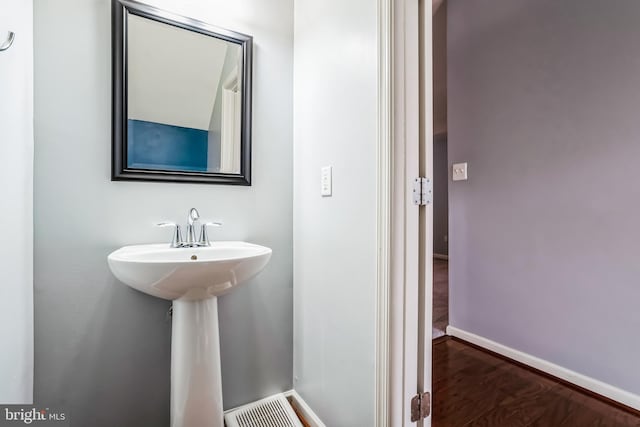 bathroom with hardwood / wood-style flooring