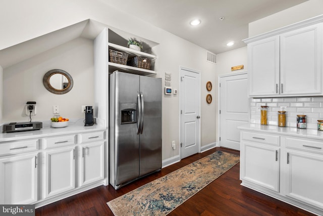 kitchen featuring white cabinets, stainless steel fridge with ice dispenser, tasteful backsplash, and dark hardwood / wood-style floors