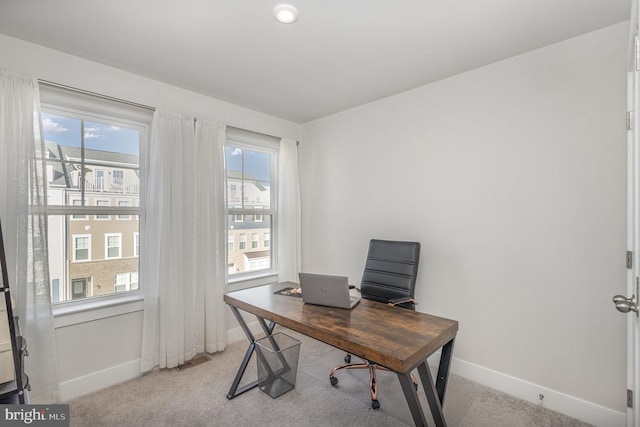 office area featuring light colored carpet