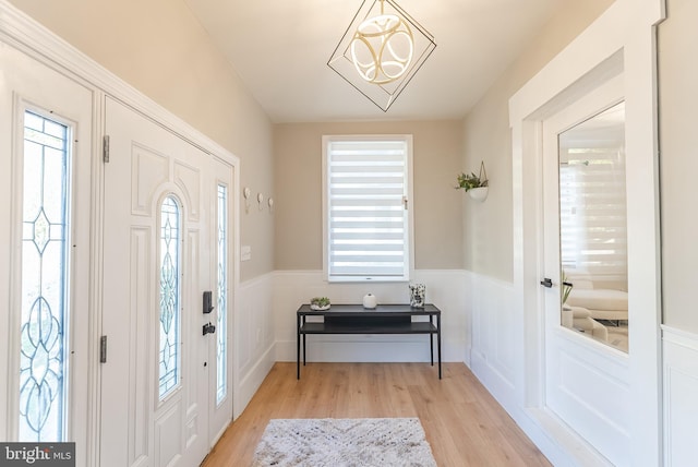 foyer entrance with light hardwood / wood-style flooring and a wealth of natural light