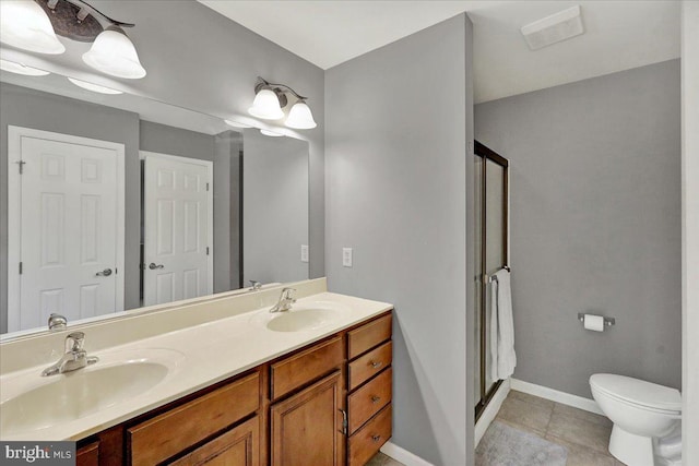 bathroom featuring tile patterned floors, vanity, an enclosed shower, and toilet