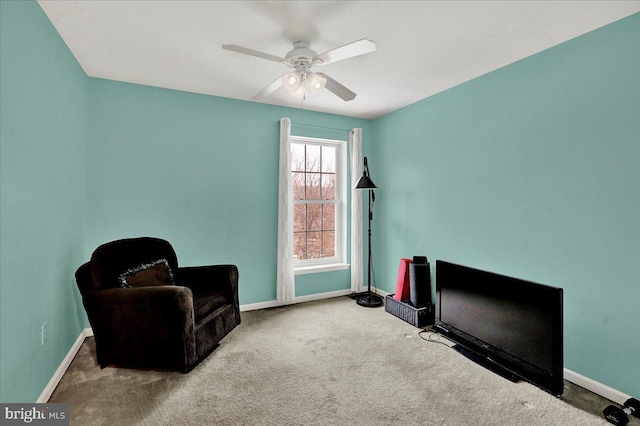 sitting room featuring light colored carpet and ceiling fan