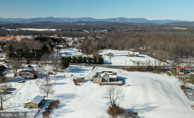 snowy aerial view with a mountain view