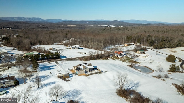 snowy aerial view with a mountain view