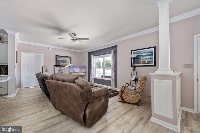 living room with decorative columns, ceiling fan, and crown molding