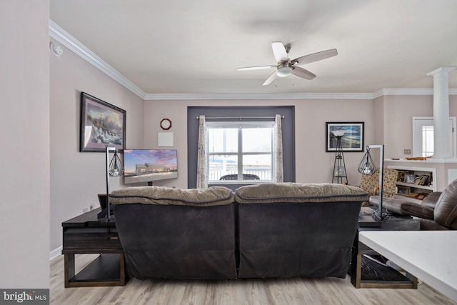 living room featuring ceiling fan, ornamental molding, and light hardwood / wood-style floors