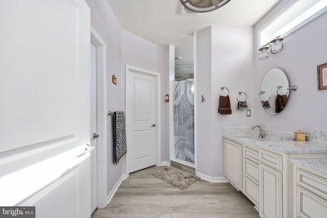 bathroom featuring hardwood / wood-style floors, vanity, and a shower with curtain