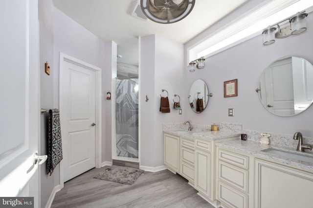 bathroom featuring wood-type flooring, vanity, and a shower with curtain