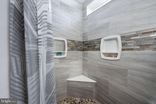 bathroom with tiled shower