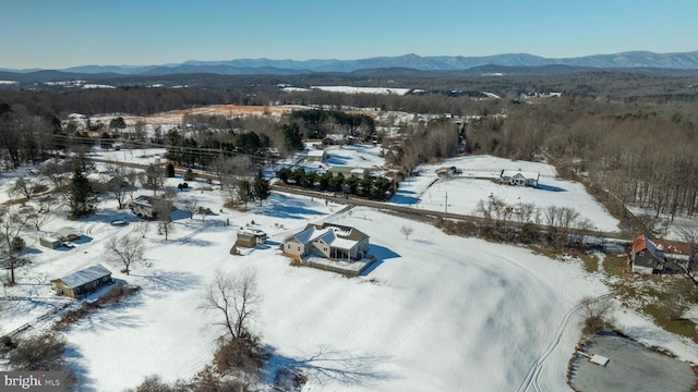 snowy aerial view with a mountain view