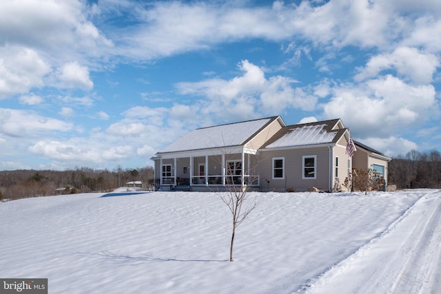 view of snow covered back of property