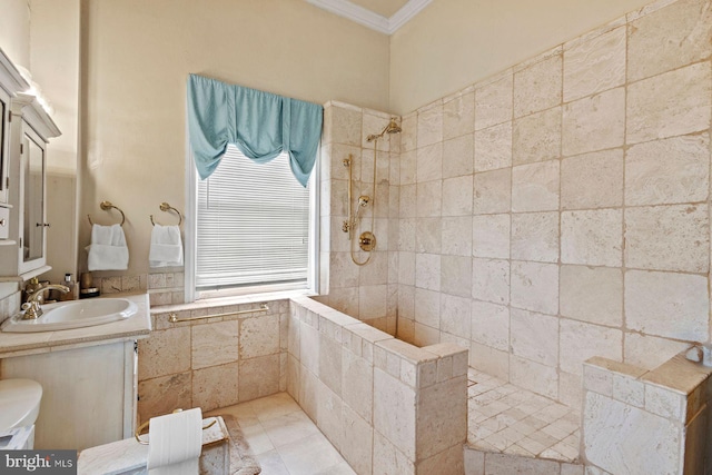 bathroom with vanity, ornamental molding, and tiled shower