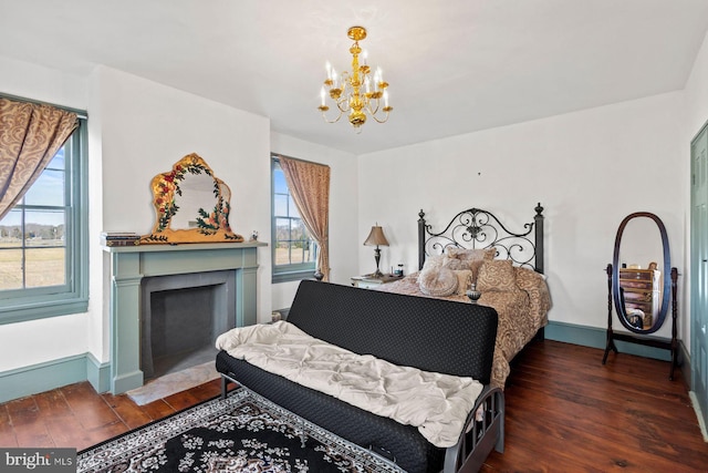 bedroom with dark wood-type flooring and an inviting chandelier