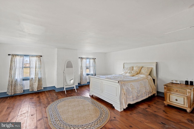 bedroom with dark wood-type flooring