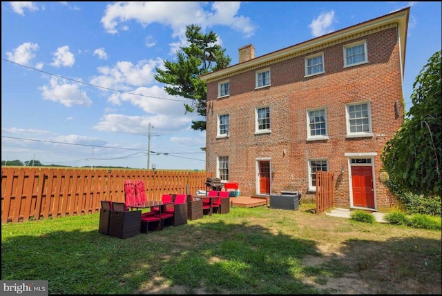 exterior space with a lawn and central AC