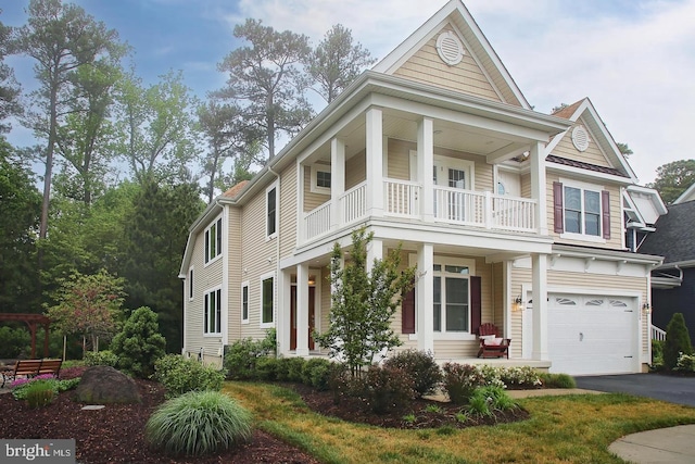 view of front of house featuring a garage and a balcony