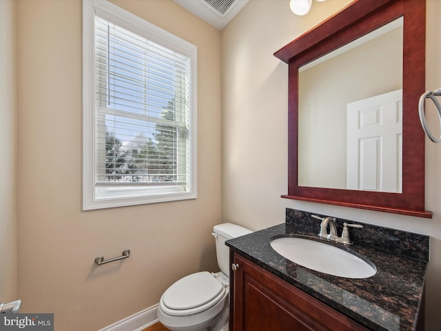 bathroom featuring vanity and toilet