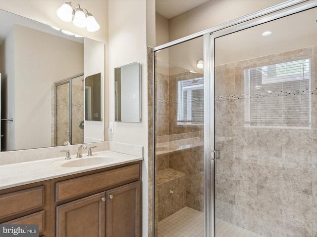 bathroom featuring vanity and an enclosed shower