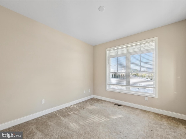 unfurnished room with light colored carpet