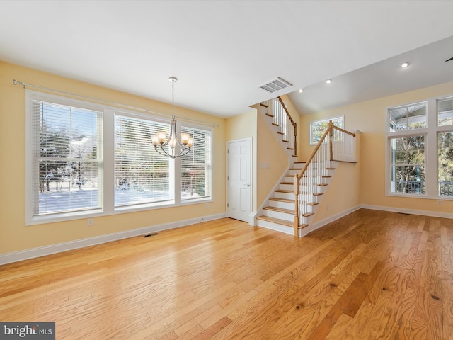 interior space featuring a chandelier and light hardwood / wood-style flooring