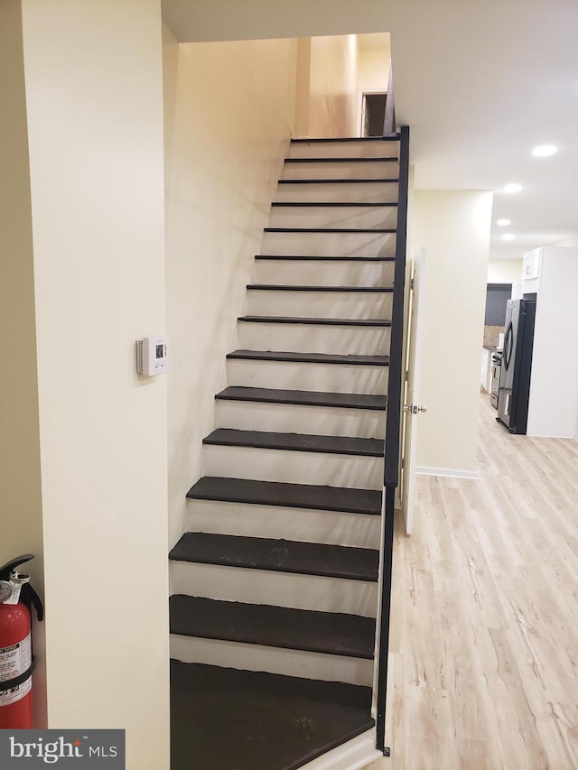 stairway featuring hardwood / wood-style floors