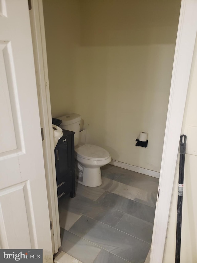 bathroom featuring tile patterned floors, vanity, and toilet