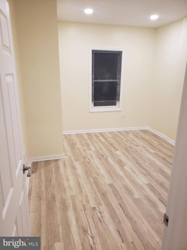 empty room with light hardwood / wood-style flooring