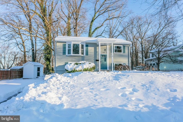 view of front of property featuring a storage shed