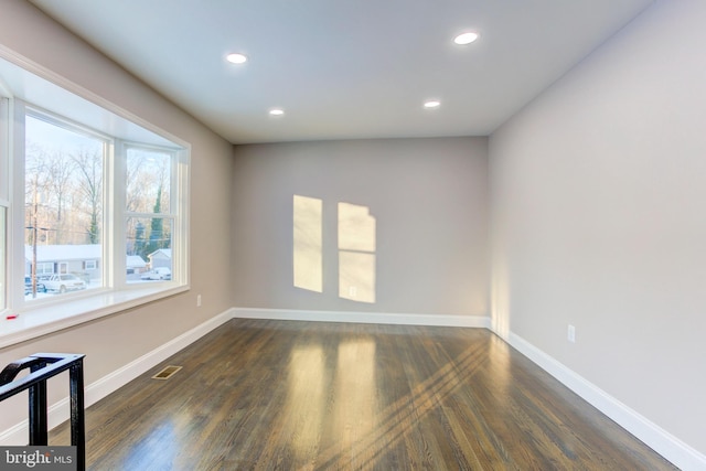 spare room featuring dark hardwood / wood-style floors