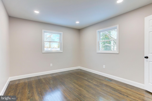 unfurnished room with dark hardwood / wood-style floors