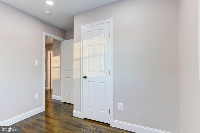 unfurnished bedroom with dark wood-type flooring