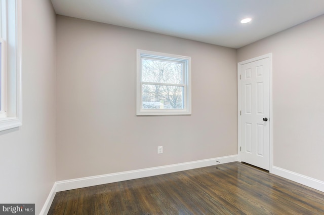 spare room with dark hardwood / wood-style floors